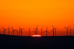first light wind turbines and rising sun landscape