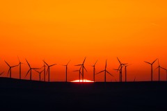 first light wind turbines and rising sun landscape